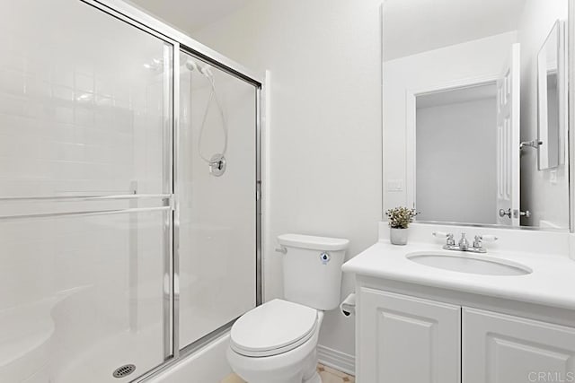 full bath with a stall shower, toilet, and vanity