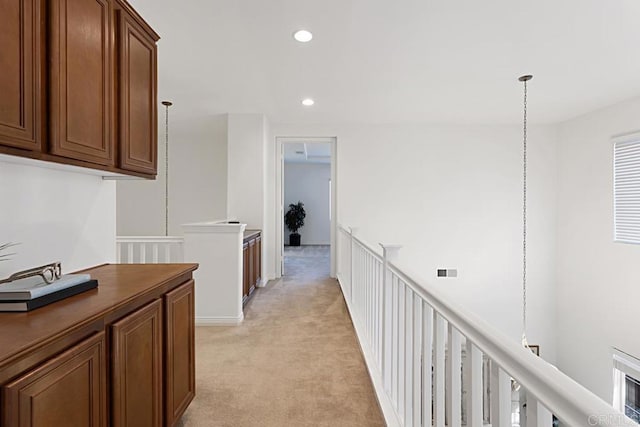 corridor with recessed lighting, visible vents, light colored carpet, and an upstairs landing