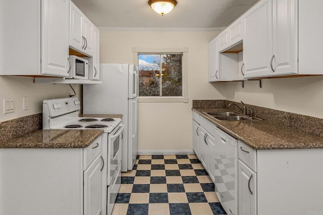 kitchen featuring a sink, white appliances, tile patterned floors, and white cabinetry