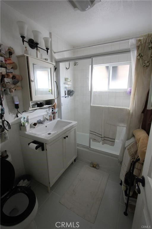 bathroom featuring vanity, tile patterned floors, and toilet