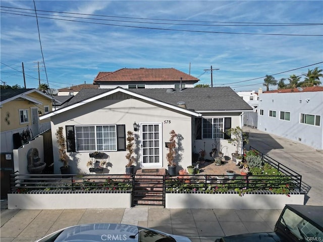 view of front of house featuring a fenced front yard and stucco siding