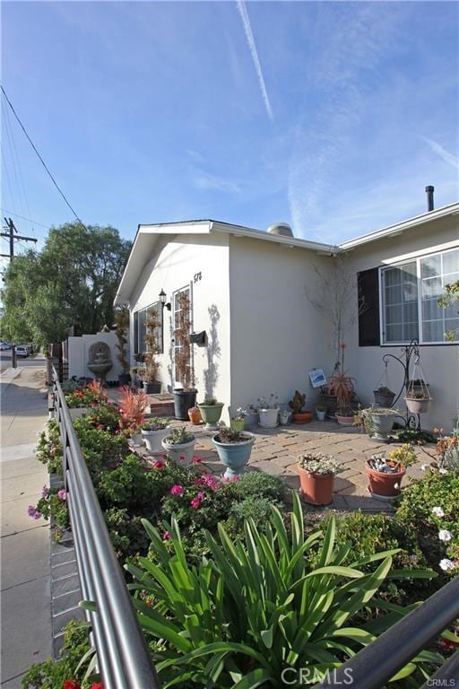 view of side of property featuring a patio and fence