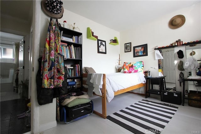 bedroom featuring concrete floors