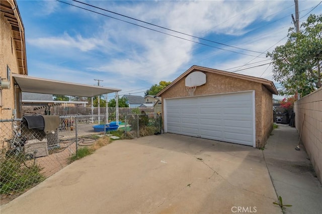 detached garage featuring fence