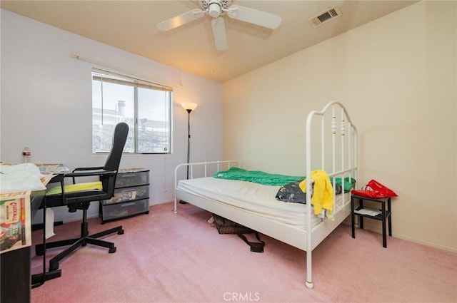 carpeted bedroom with visible vents and ceiling fan