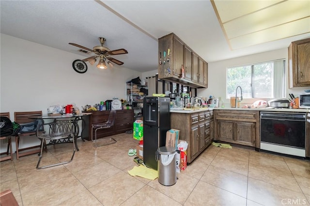 kitchen featuring visible vents, a sink, light countertops, light tile patterned floors, and dishwasher