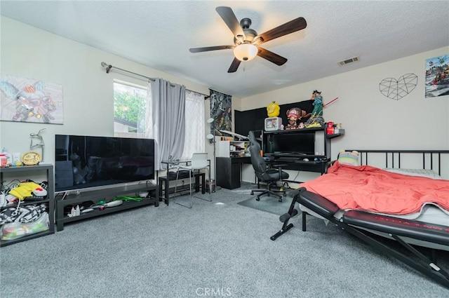 bedroom with visible vents, a textured ceiling, and ceiling fan