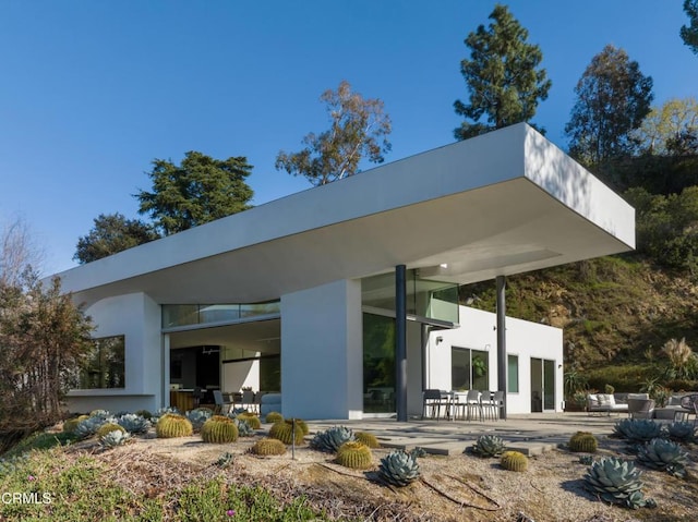 back of house with a patio and stucco siding