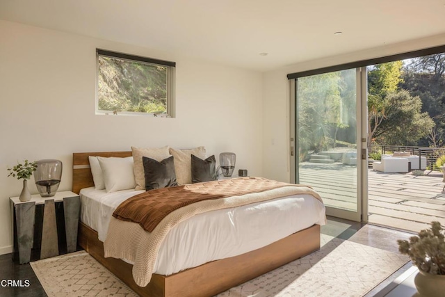 bedroom featuring access to exterior and floor to ceiling windows