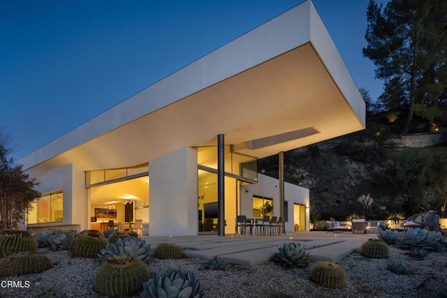 rear view of property with a patio area and stucco siding