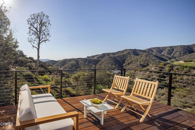 wooden deck featuring a mountain view