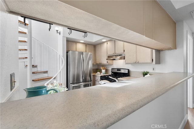 kitchen featuring under cabinet range hood, recessed lighting, appliances with stainless steel finishes, and light countertops