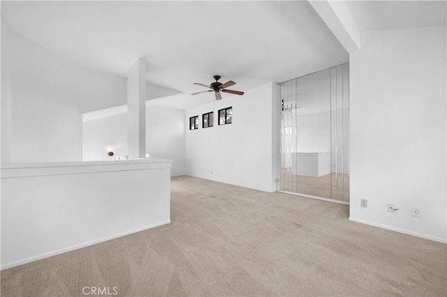 empty room with a ceiling fan and carpet floors