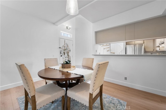 dining area with visible vents, baseboards, and wood finished floors