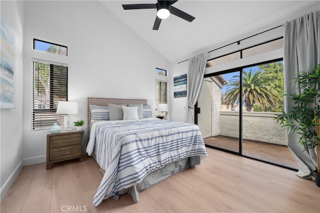 bedroom featuring access to outside, wood finished floors, baseboards, and high vaulted ceiling