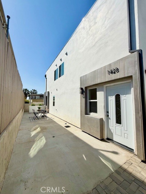 rear view of house featuring a patio and stucco siding