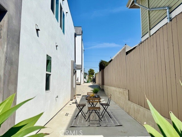 view of patio featuring outdoor dining area and fence