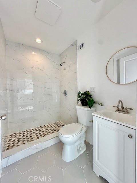 bathroom featuring visible vents, vanity, toilet, recessed lighting, and a shower stall