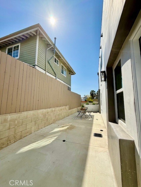 view of home's exterior with fence and a patio