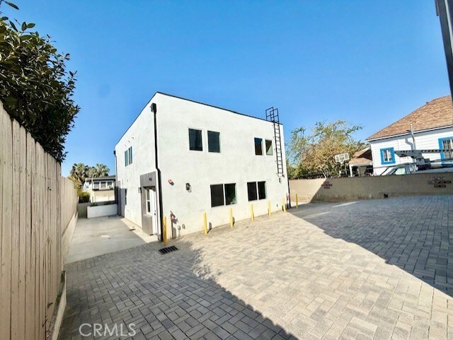 back of property featuring a fenced backyard, a patio area, and stucco siding