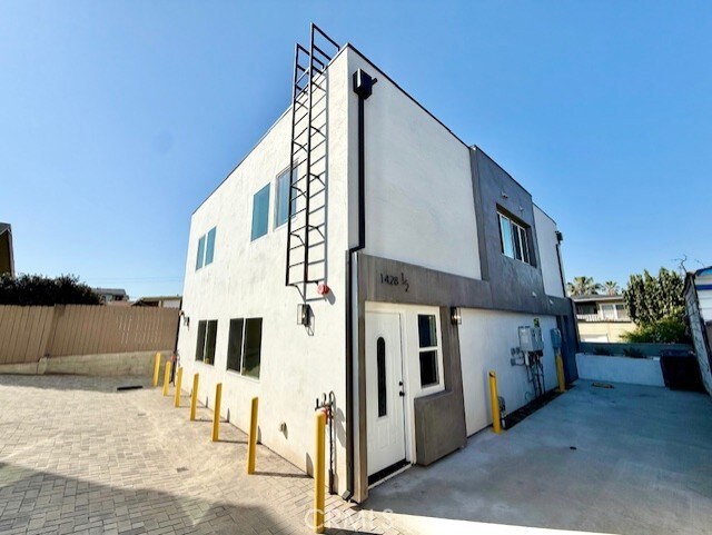 back of house featuring fence, a patio, and stucco siding