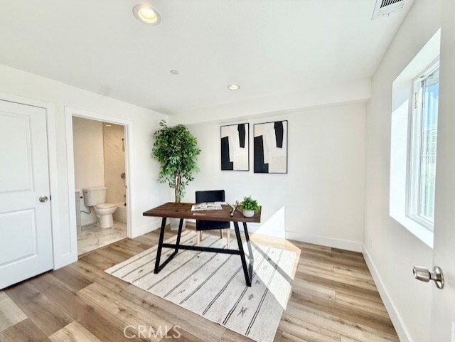 office area with recessed lighting, baseboards, visible vents, and light wood-type flooring