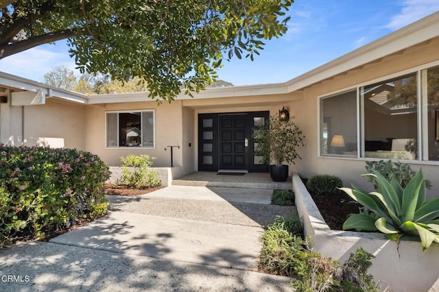 property entrance with stucco siding