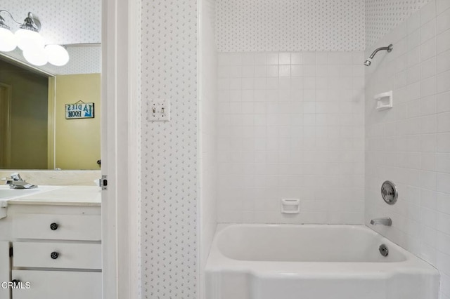 full bath featuring wallpapered walls, vanity, and washtub / shower combination