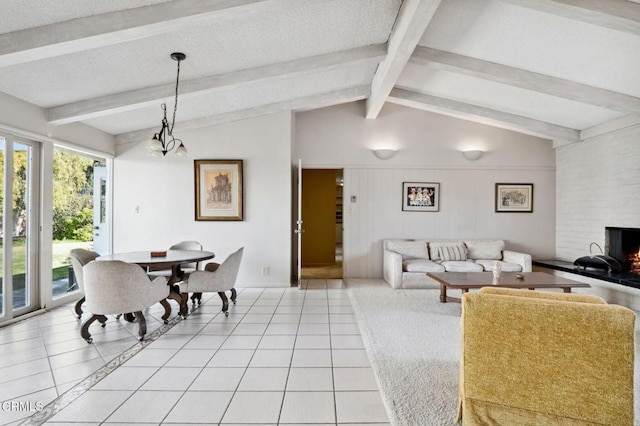 living area with a wealth of natural light, a textured ceiling, and light tile patterned floors