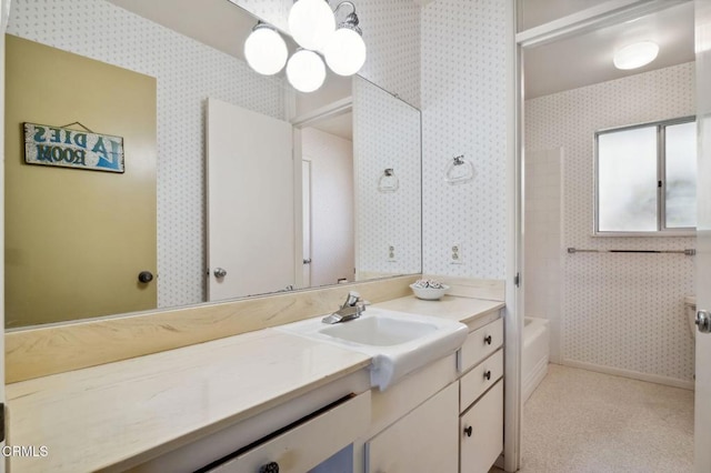 bathroom featuring wallpapered walls and vanity