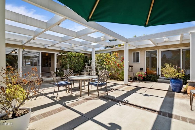 view of patio featuring outdoor dining space and a pergola