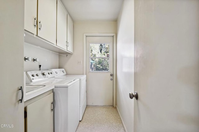 laundry room with cabinet space, baseboards, and washer and clothes dryer