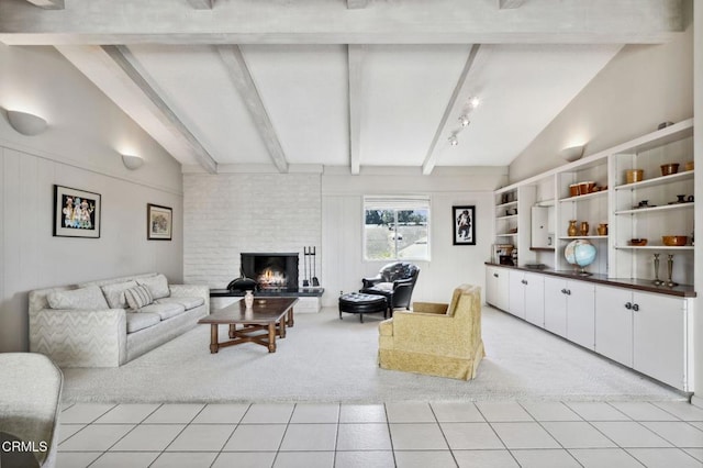 living area featuring light tile patterned floors, a brick fireplace, vaulted ceiling with beams, and light carpet