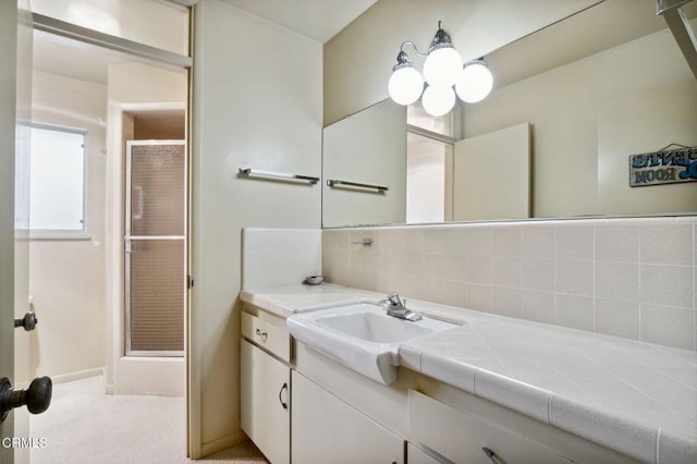 full bathroom with tasteful backsplash, a stall shower, and vanity