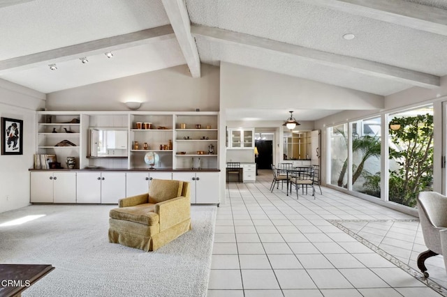 living room with lofted ceiling with beams, light tile patterned floors, and a textured ceiling