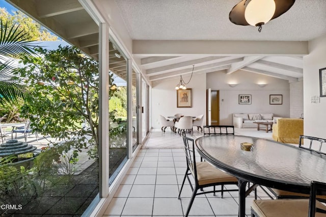 dining space with light tile patterned floors, a textured ceiling, and lofted ceiling with beams