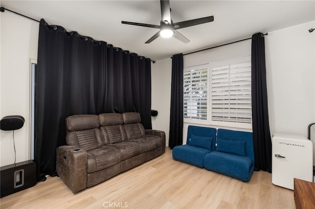 living room featuring wood finished floors and ceiling fan