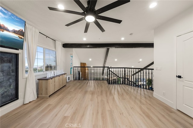 empty room featuring baseboards, lofted ceiling with beams, recessed lighting, light wood-style flooring, and a ceiling fan