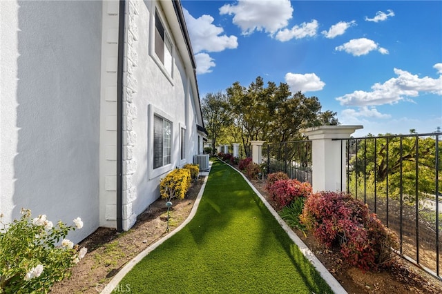 view of yard featuring cooling unit and fence