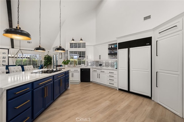 kitchen featuring visible vents, blue cabinetry, white cabinets, gas stovetop, and open shelves