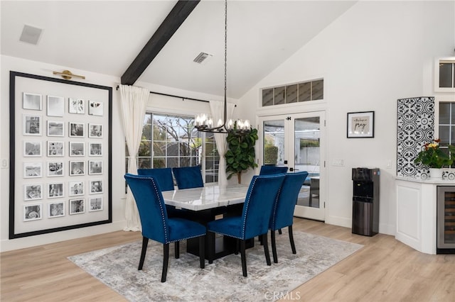 dining room with visible vents, high vaulted ceiling, wine cooler, light wood-type flooring, and a chandelier