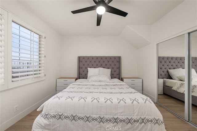 bedroom with light wood-style flooring, baseboards, a closet, and ceiling fan