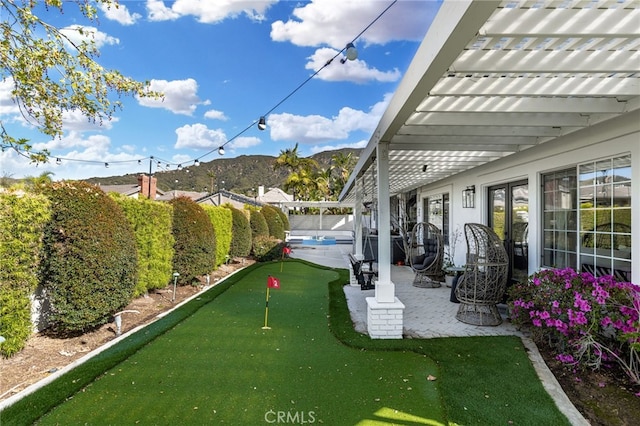 view of patio / terrace with a mountain view and a fenced backyard