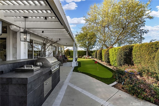 view of patio / terrace with exterior kitchen, a pergola, and a grill