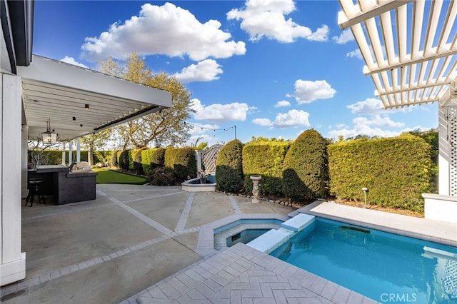 view of swimming pool with a patio and a pool with connected hot tub