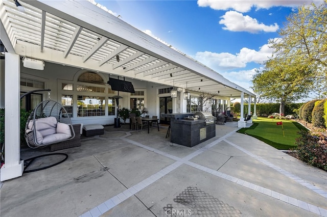 view of patio with area for grilling, exterior kitchen, and a pergola