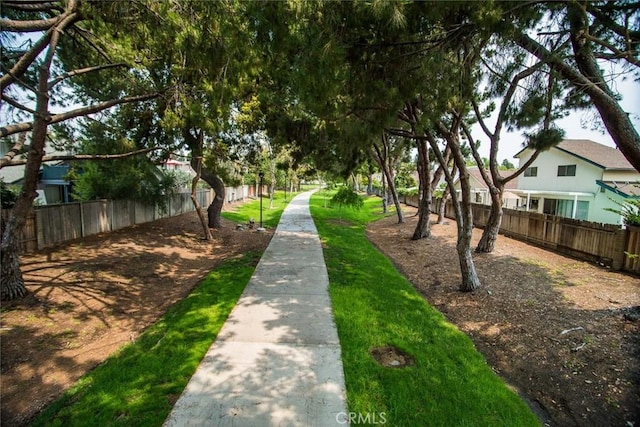 view of home's community featuring fence