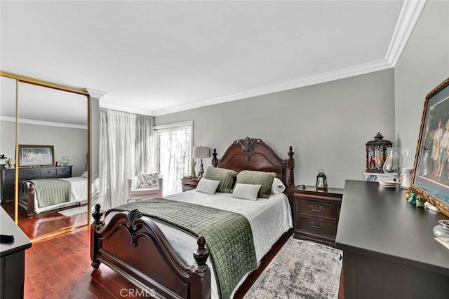 bedroom featuring dark wood finished floors and ornamental molding