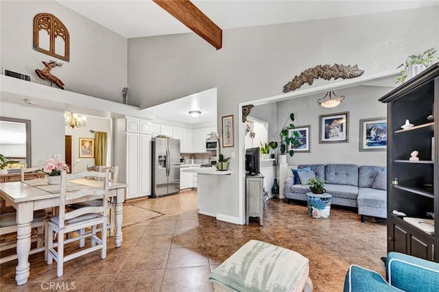 living room featuring visible vents, beamed ceiling, high vaulted ceiling, light tile patterned flooring, and a chandelier