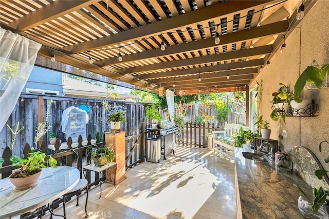 view of patio with fence, a pergola, and a grill